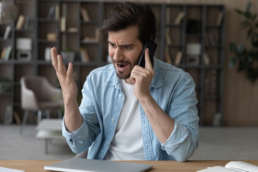 angry man talking on the phone.