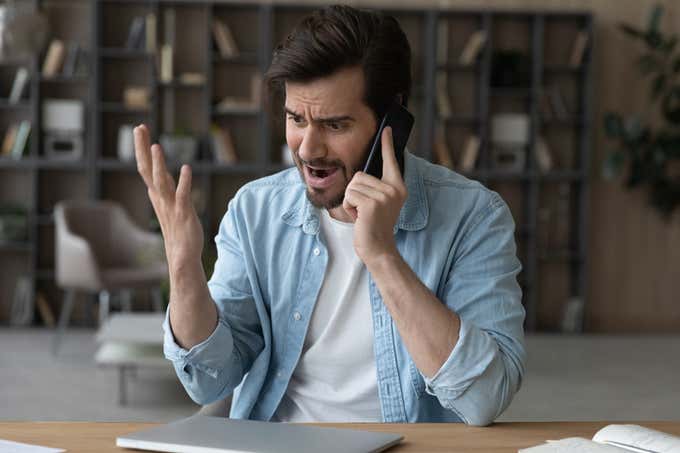 angry man talking on the phone.