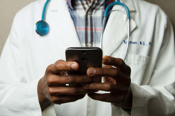 doctor taking notes on phone