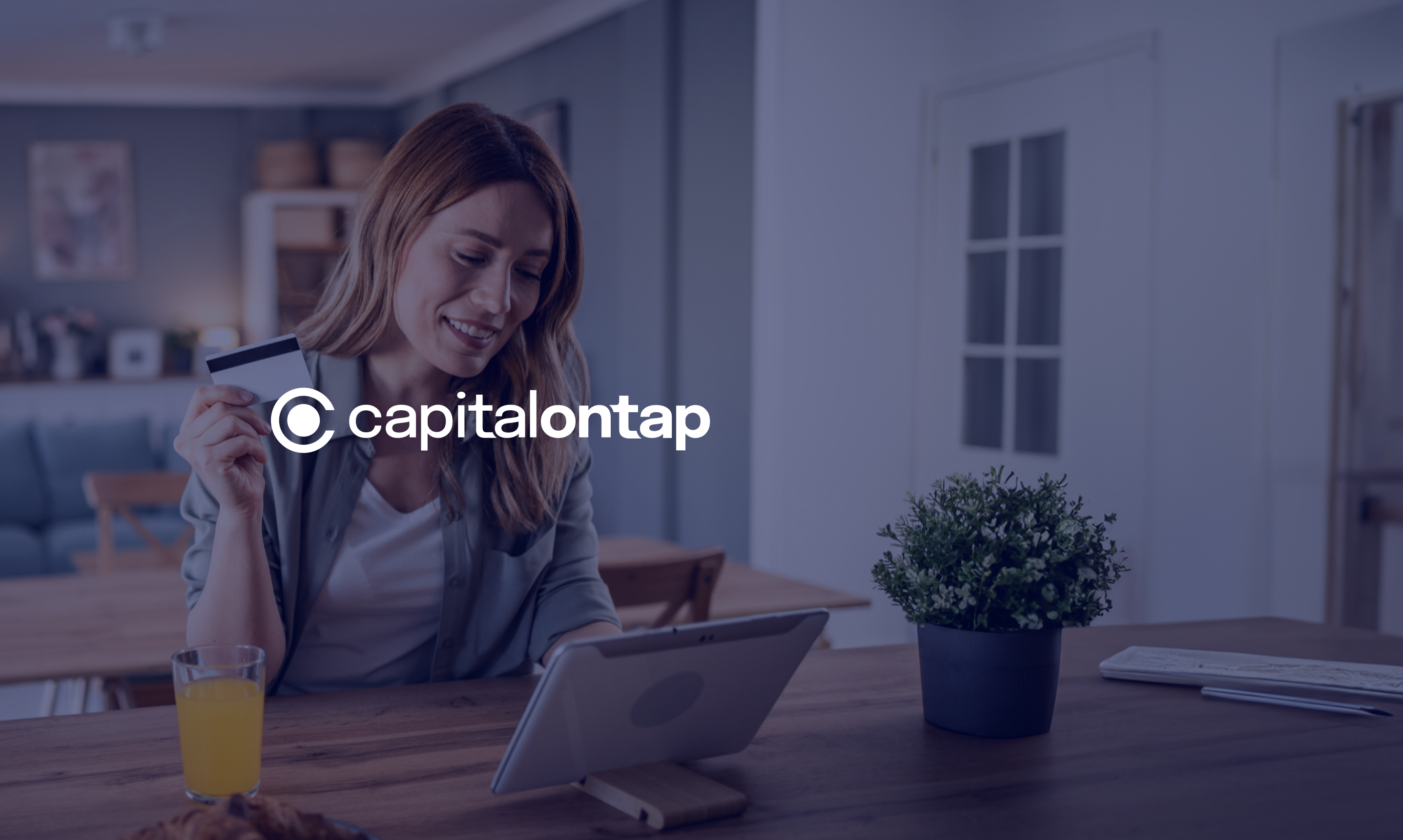Business owner using Capital on Tap credit card to make an online payment on a tablet